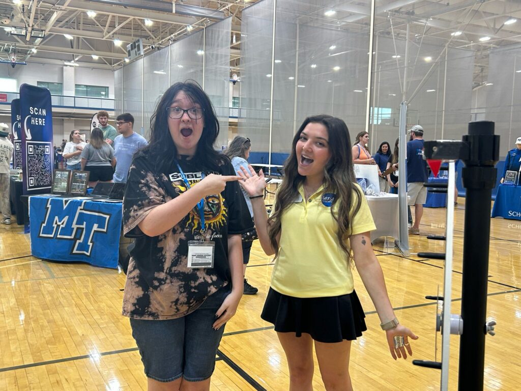 Students attending New to Blue Orientation posing for a photo with their Student Orientation Assistant.