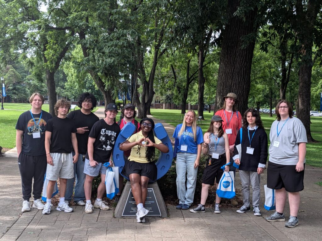 Students attending New to Blue Orientation posing for a photo with their Student Orientation Assistant.