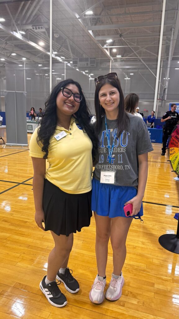 Student attending New to Blue Orientation posing for a photo with their Student Orientation Assistant.