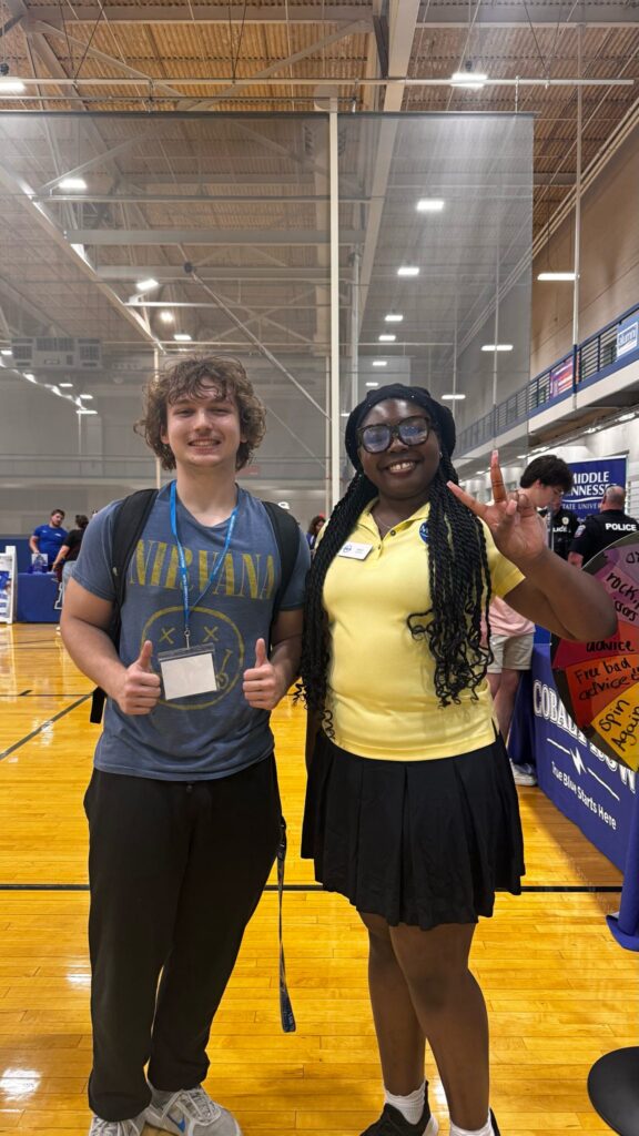 Student attending New to Blue Orientation posing for a photo with their Student Orientation Assistant.