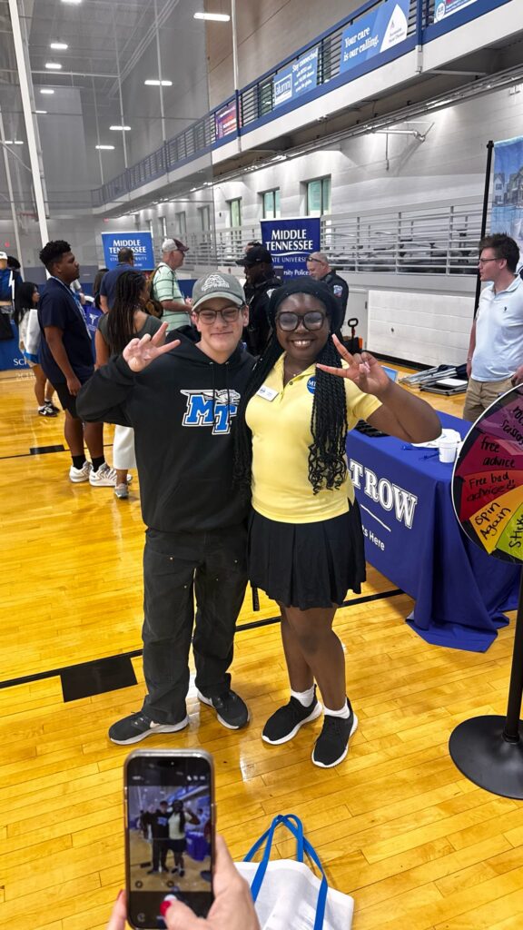 Student attending New to Blue Orientation posing for a photo with their Student Orientation Assistant.