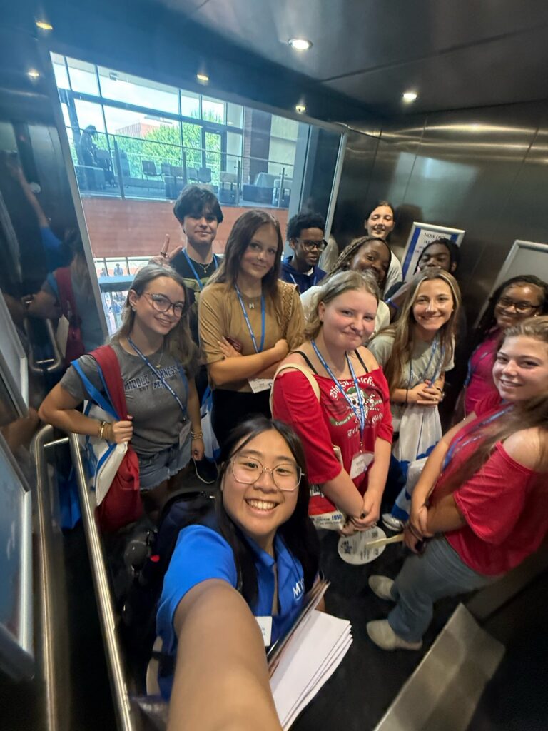 Students attending New to Blue Orientation posing for a photo with their Student Orientation Assistant.