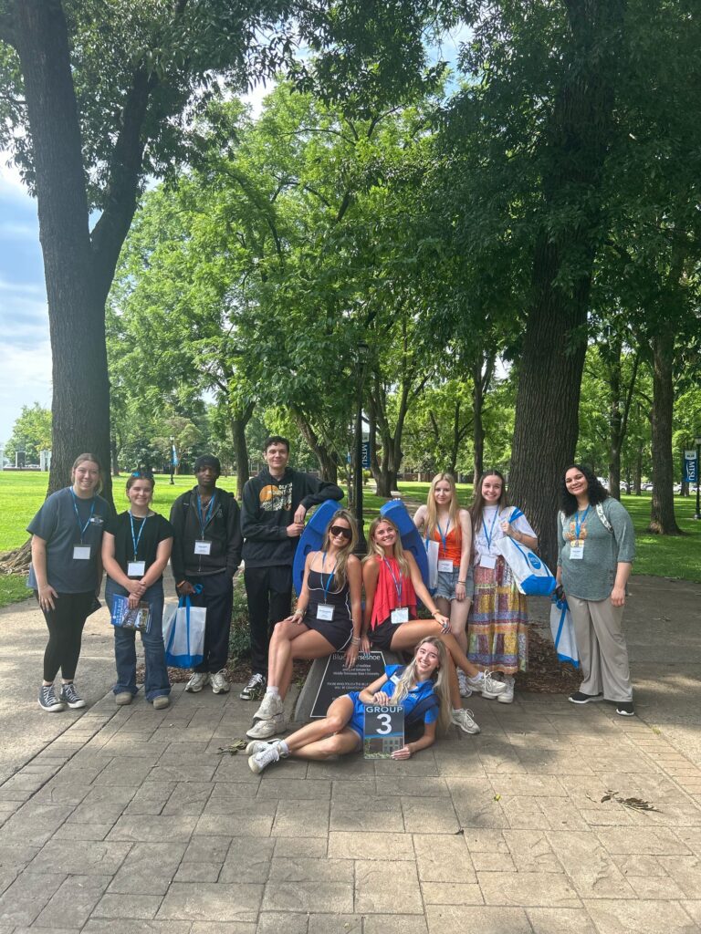 Students in Group 3 of orientation posing for a photo at the blue horseshoe at MTSU with their Student Orientation Assistant.