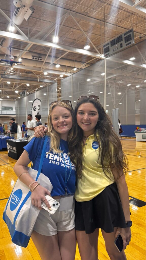 Student attending New to Blue Orientation posing for a photo with their Student Orientation Assistant.