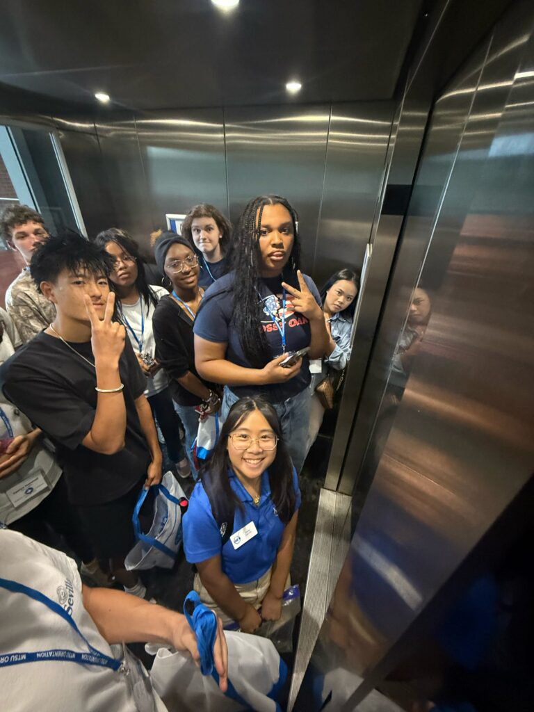 Students attending New to Blue Orientation posing for a photo with their Student Orientation Assistant.