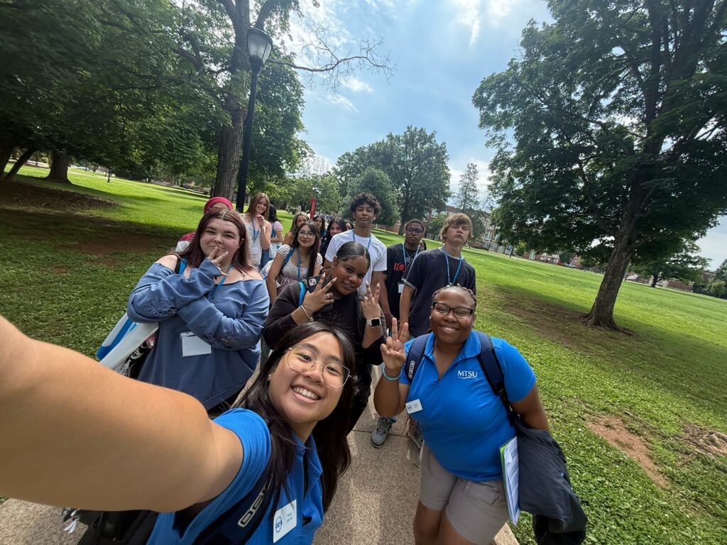 Students attending New to Blue Orientation posing for a photo with their Student Orientation Assistant.