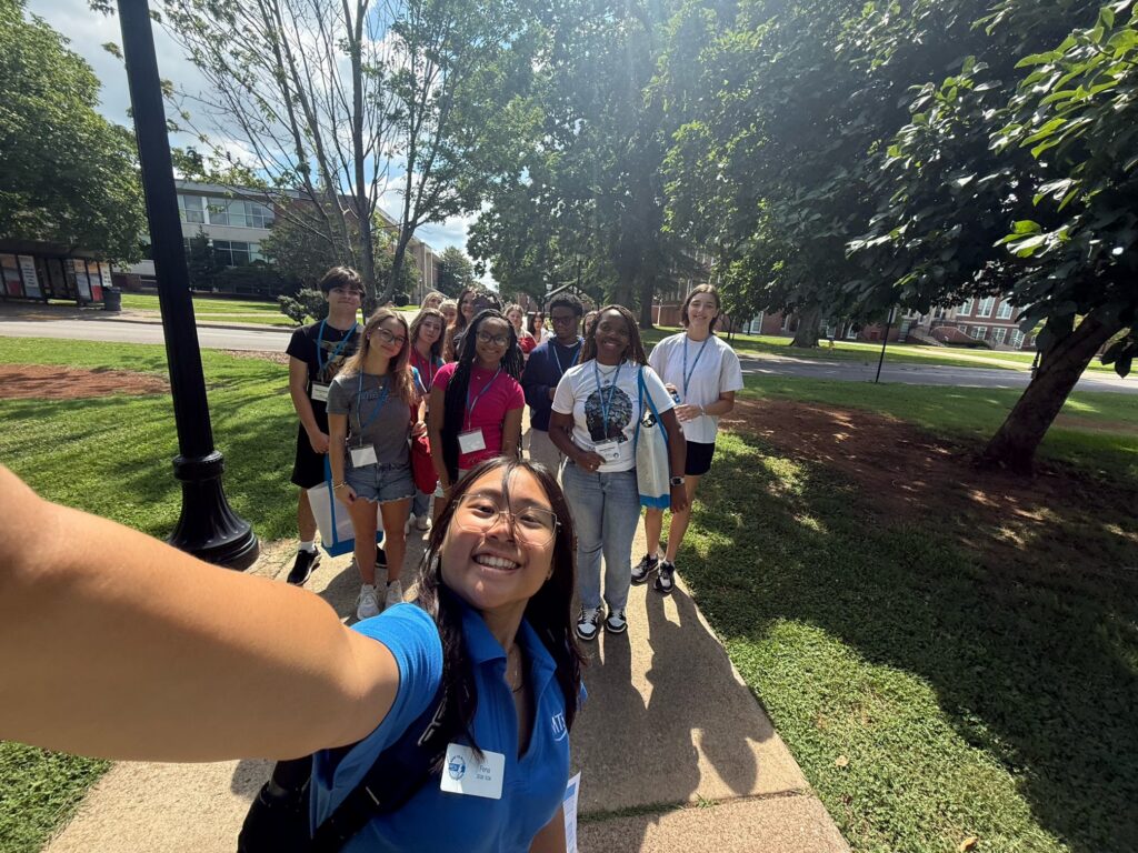 Students attending New to Blue Orientation posing for a photo with their Student Orientation Assistant.