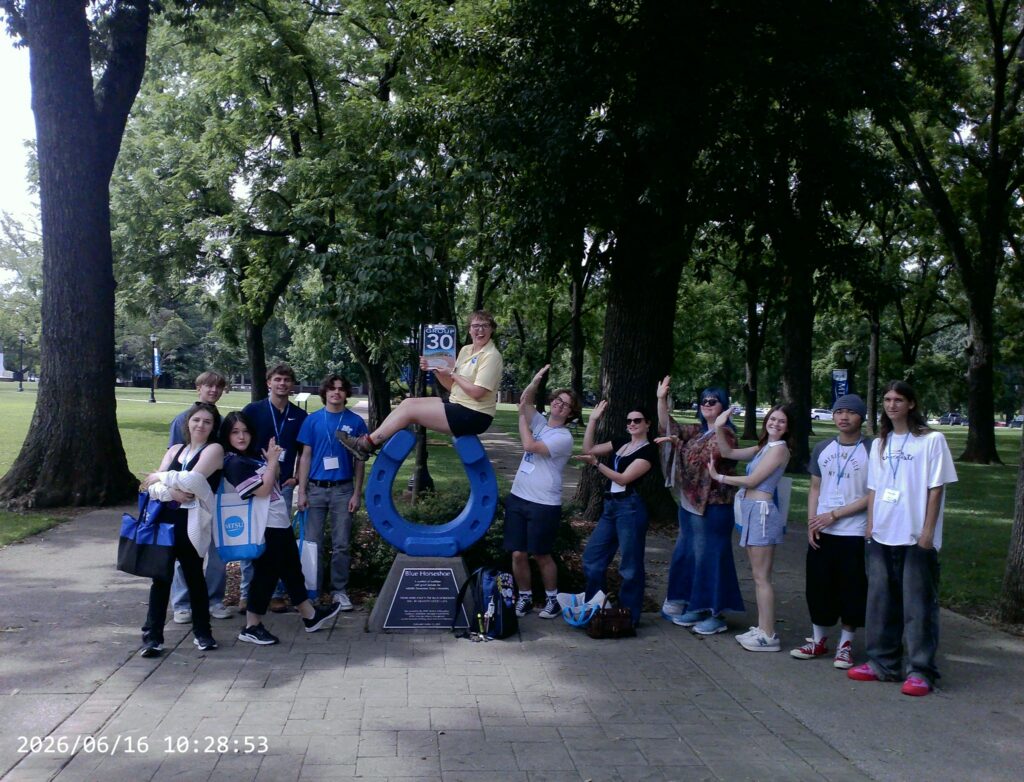 Students in Group 30 of orientation posing for a photo at the blue horseshoe at MTSU with their Student Orientation Assistant.
