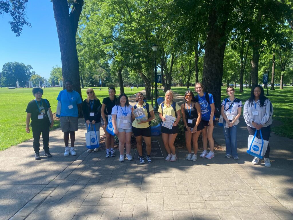 Students in Group 15 of orientation posing for a photo at the blue horseshoe at MTSU with their Student Orientation Assistant.