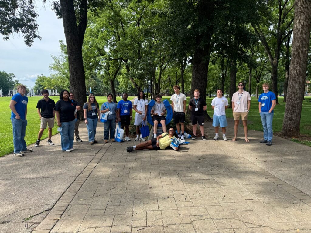 Students in Group 2 of orientation posing for a photo at the blue horseshoe at MTSU with their Student Orientation Assistant.