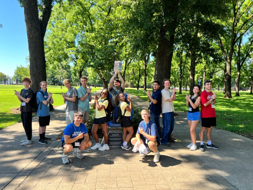 Students in Group 1 of orientation posing for a photo at the blue horseshoe at MTSU with their Student Orientation Assistants.