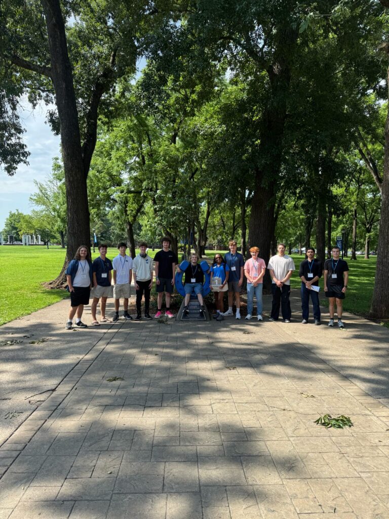 Students in Group 1 of orientation posing for a photo at the blue horseshoe at MTSU with their Student Orientation Assistant.