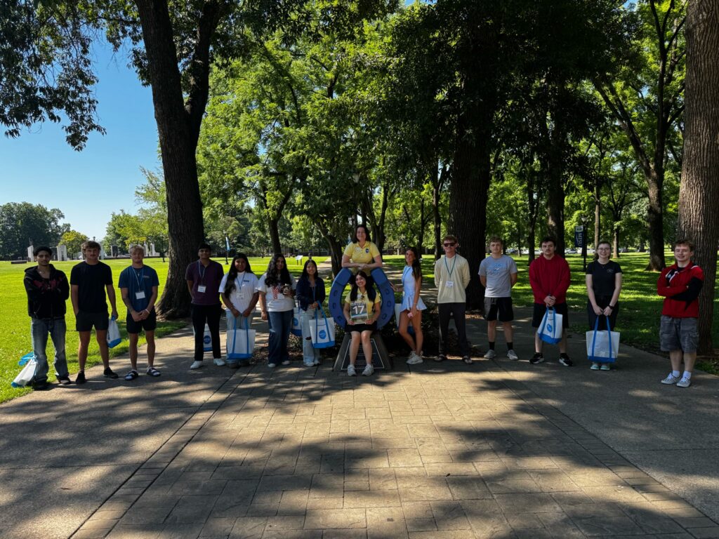 Students in Group 17 of orientation posing for a photo at the blue horseshoe at MTSU with their Student Orientation Assistants.