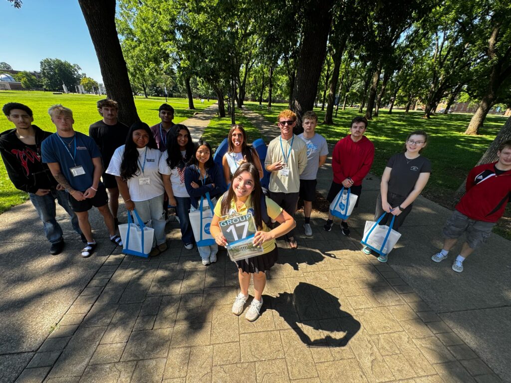 Students in Group 17 of orientation posing for a photo at the blue horseshoe at MTSU with their Student Orientation Assistants.