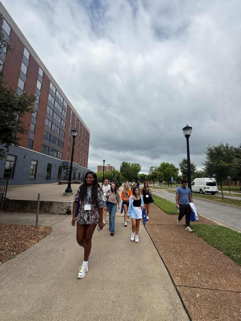 Students attending New to Blue Orientation walking outside near Cummings and Corlew Hall.
