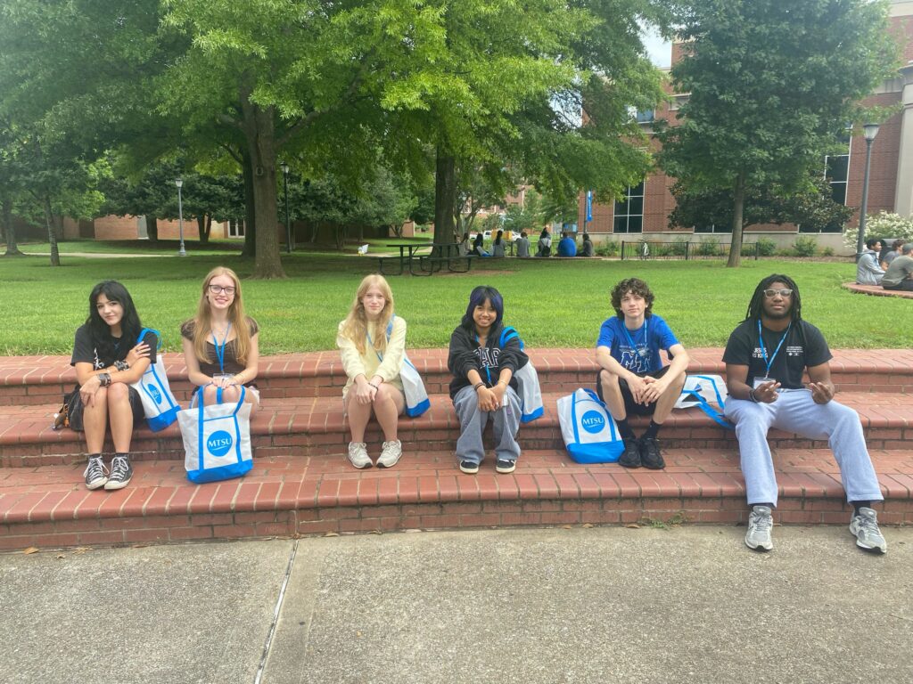 Students attending New to Blue Orientation posing for a photo outside.