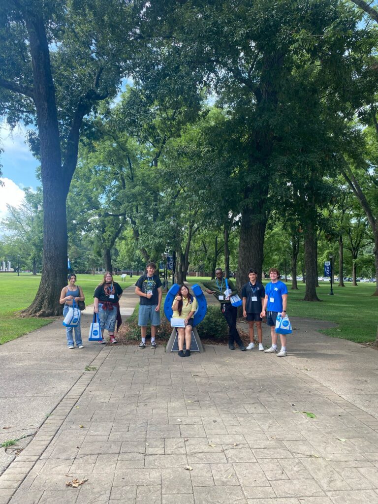 Students attending New to Blue Orientation posing for a photo with their Student Orientation Assistant.