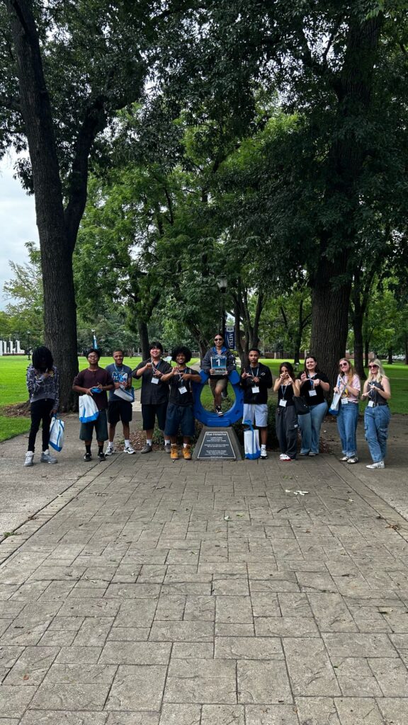 Students in Group 1 of orientation posing for a photo at the blue horseshoe at MTSU with their Student Orientation Assistant.