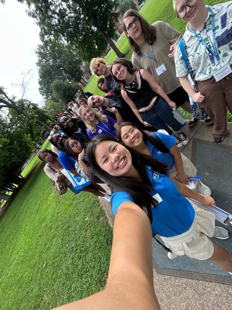 Students attending orientation standing outside posing for a photo with their Student Orientation Assistants.