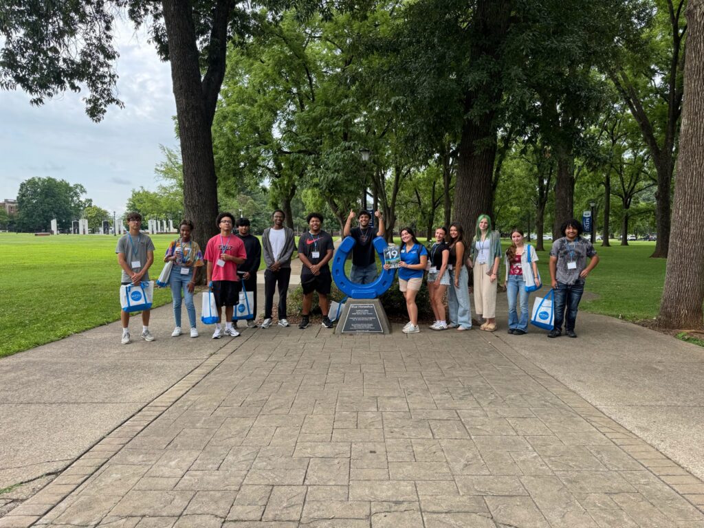 Students in Group 19 of orientation posing for a photo at the blue horseshoe at MTSU with their Student Orientation Assistant.