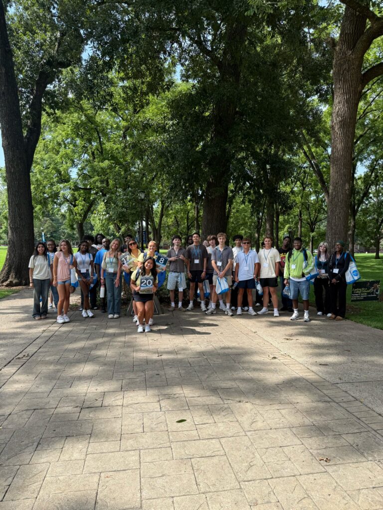Students in Group 20 and 8 of orientation posing for a photo at the blue horseshoe at MTSU with their Student Orientation Assistants.