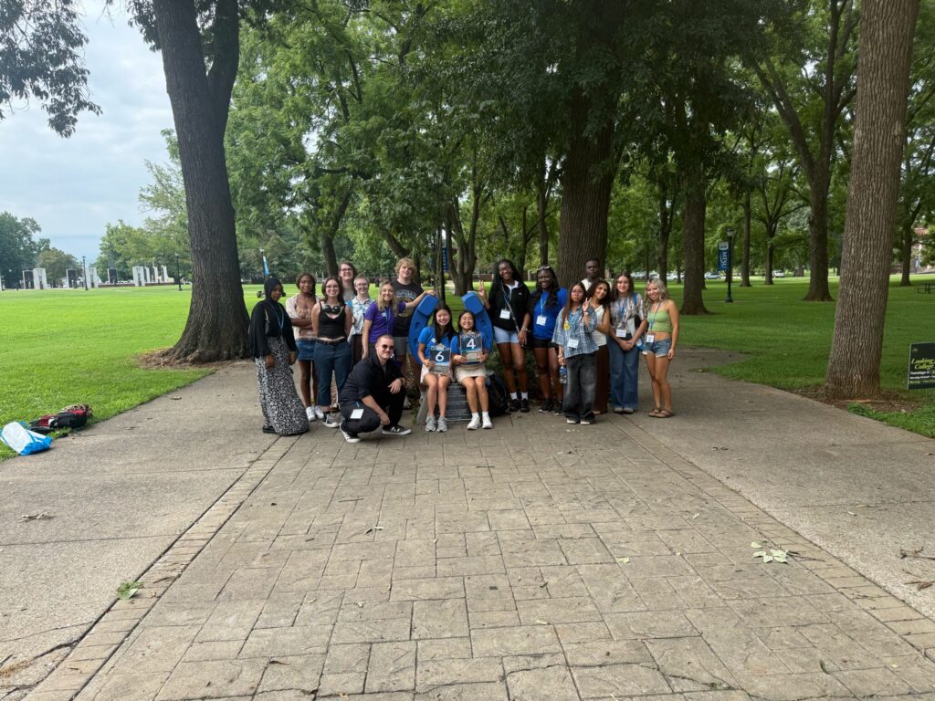 Students in Group 6 and Group 4 of orientation posing for a photo at the blue horseshoe at MTSU with their Student Orientation Assistants