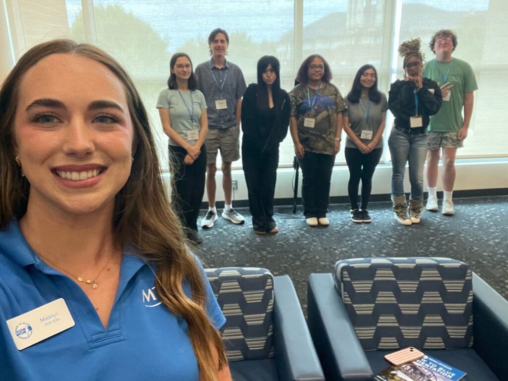 Students attending New to Blue Orientation posing for a photo with their Student Orientation Assistant.