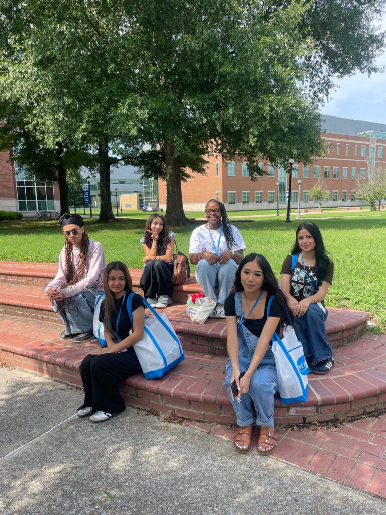 Students attending orientation sitting outside.