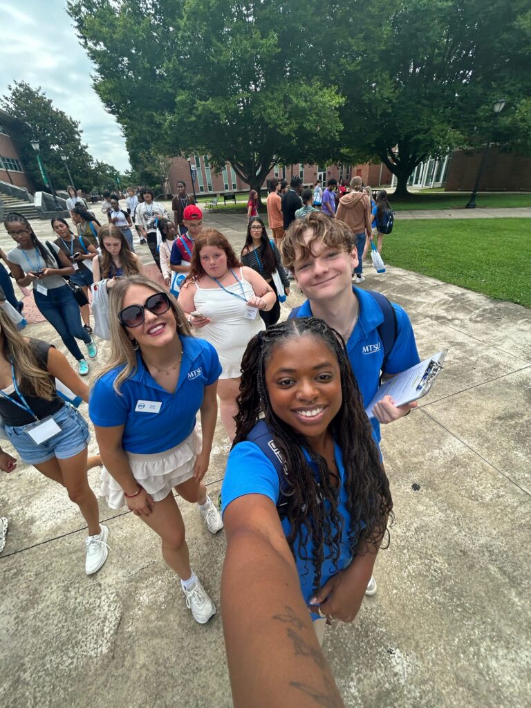 Student Orientation Assistants posing for an image with students behind them.