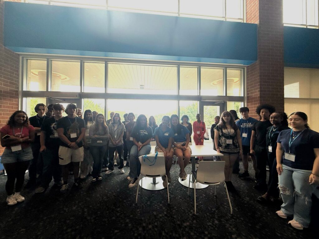 Students attending New to Blue Orientation posing for a photo with their Student Orientation Assistant.