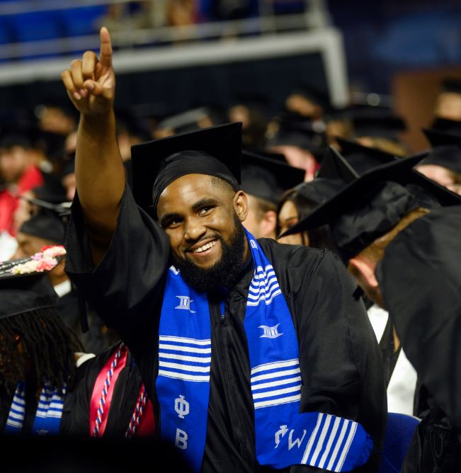 man seated at an mtsu commencement ceremony 