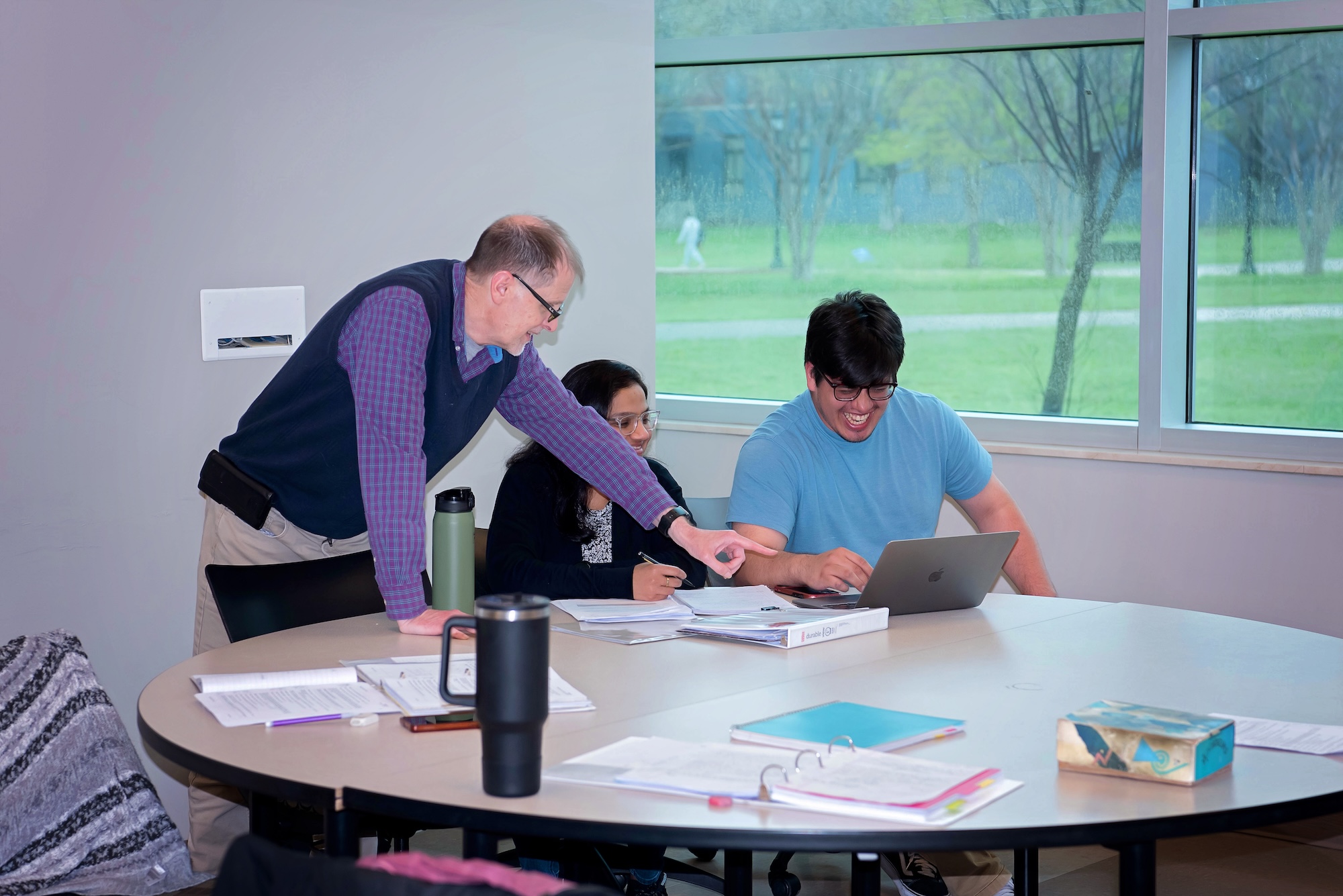 2 general mathematics students being taught by a professor